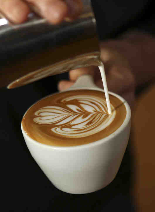 Robin Myers pours a flat white with a tulip design at Pistacia Vera in German Village on Wednesday, September 19, 2018.   (Jonathan Quilter / The Columbus Dispatch)